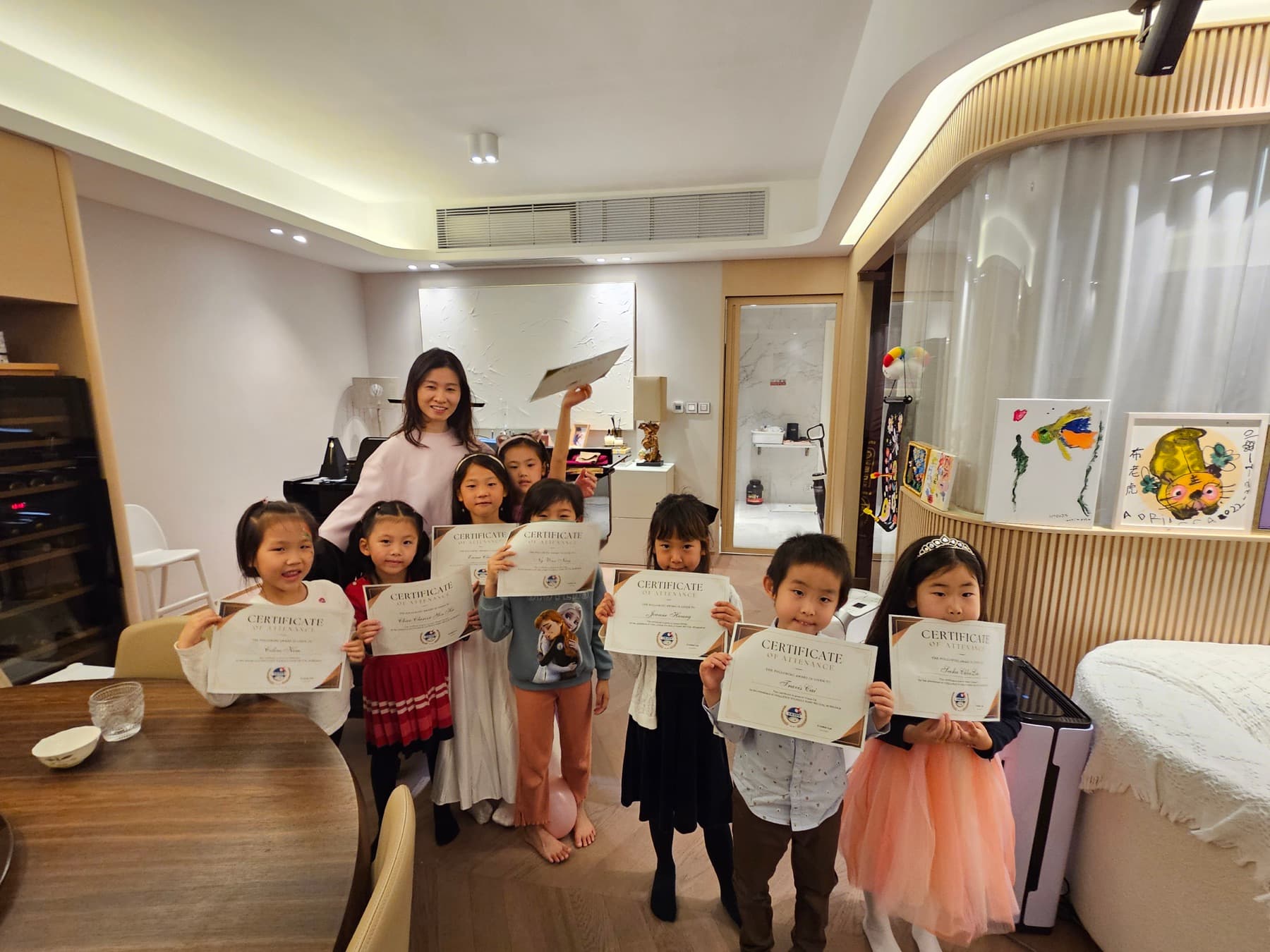 Children holding certificates after completing a learning milestone