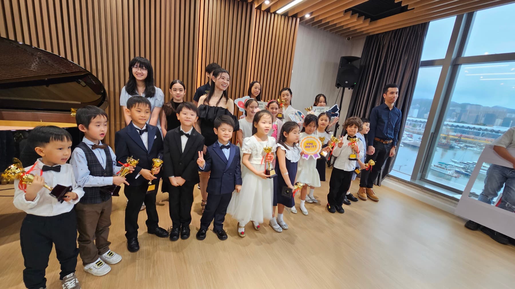 Children and teachers celebrating together after the annual performance